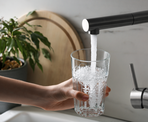 Person getting water from the tap